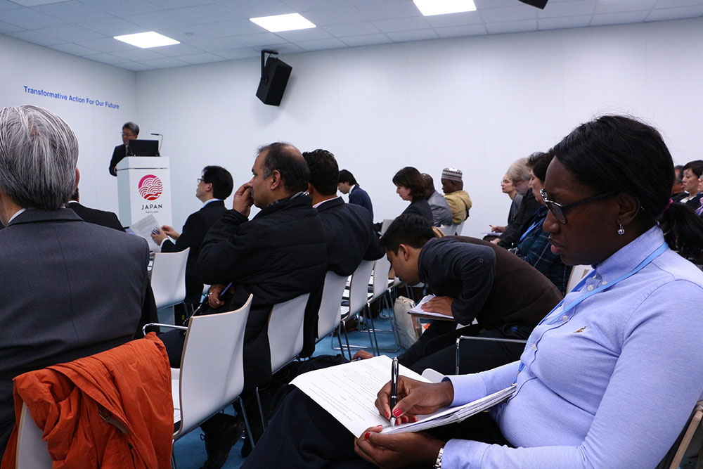 An audience is taking notes at the side event in Japan pavilion